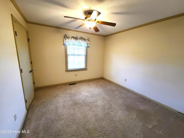 carpeted spare room with crown molding, ceiling fan, and a textured ceiling