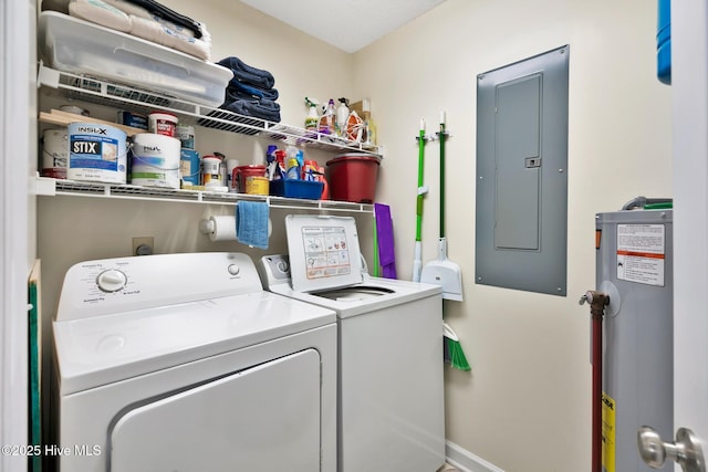 clothes washing area with washing machine and clothes dryer, electric panel, and water heater