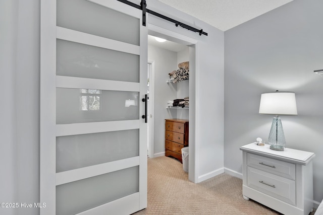 interior space featuring a barn door and light colored carpet