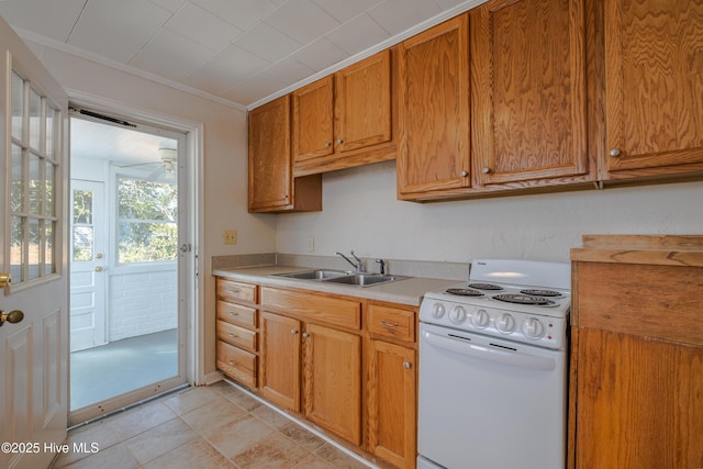 kitchen featuring sink, crown molding, light tile patterned flooring, and white range with electric cooktop