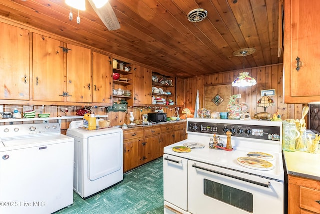 kitchen featuring wooden walls, decorative light fixtures, separate washer and dryer, double oven range, and wooden ceiling