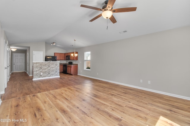 unfurnished living room with light wood-style floors, a ceiling fan, vaulted ceiling, visible vents, and baseboards
