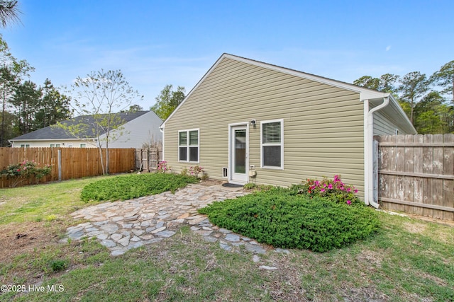 back of property featuring a patio, a fenced backyard, and a lawn