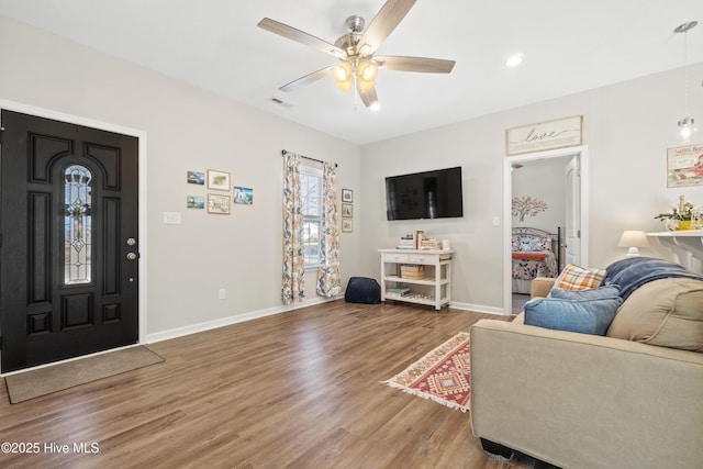 living room with hardwood / wood-style flooring and ceiling fan