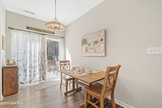 dining area featuring dark hardwood / wood-style flooring