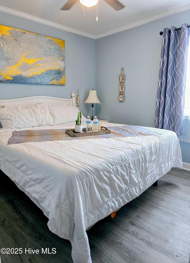 bedroom featuring ceiling fan, ornamental molding, and wood-type flooring