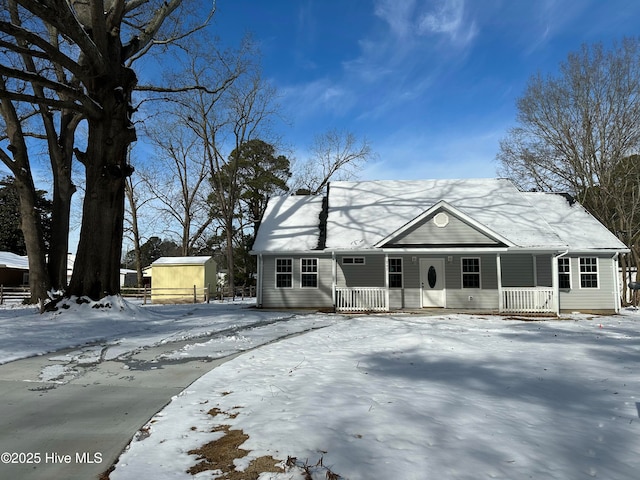 view of front facade with a porch and a storage shed