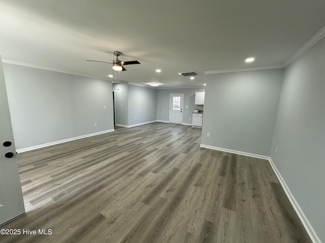 unfurnished living room featuring hardwood / wood-style flooring, ceiling fan, and crown molding