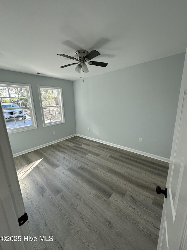 unfurnished room with hardwood / wood-style flooring and ceiling fan