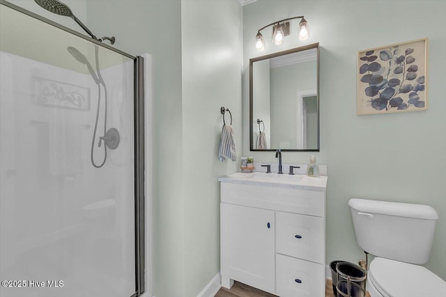 bathroom featuring vanity, toilet, and an enclosed shower