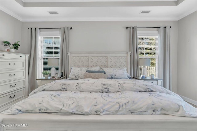 unfurnished bedroom featuring ornamental molding and a tray ceiling