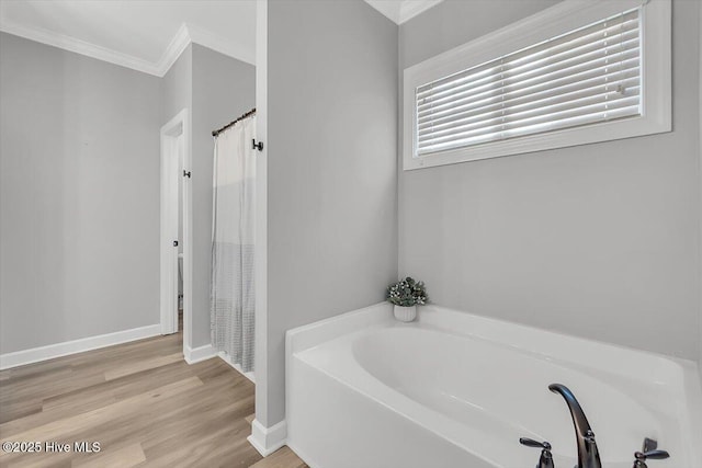 bathroom featuring hardwood / wood-style floors, ornamental molding, and shower with separate bathtub