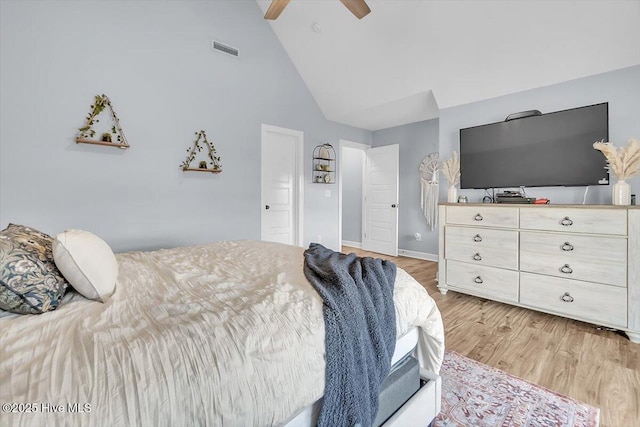 bedroom with ceiling fan, high vaulted ceiling, and light hardwood / wood-style floors