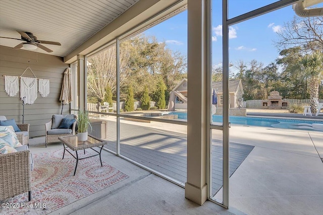 sunroom featuring ceiling fan