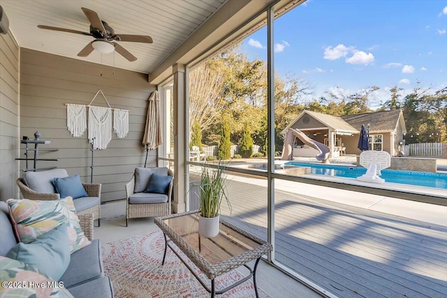 unfurnished sunroom featuring ceiling fan