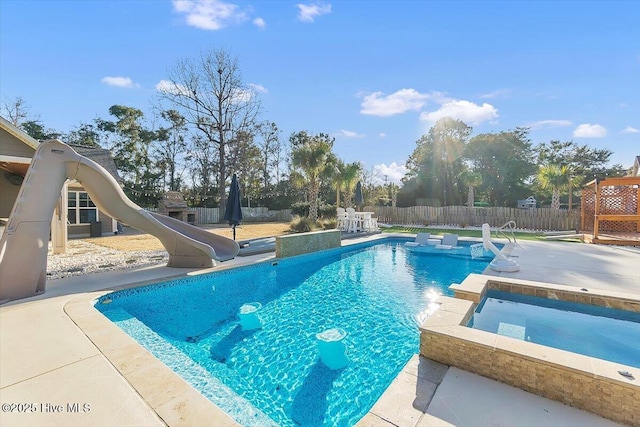 view of swimming pool with an in ground hot tub, a patio, and a water slide