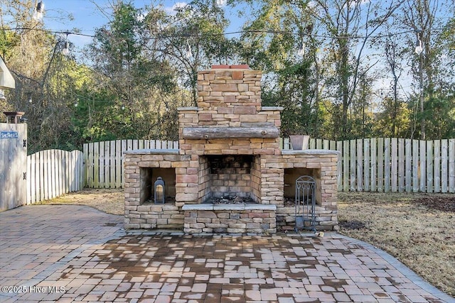 view of patio / terrace featuring an outdoor stone fireplace