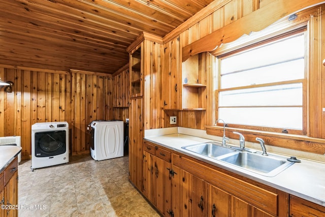 laundry area with washer / clothes dryer, sink, wood ceiling, and wood walls