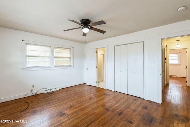 unfurnished bedroom featuring ceiling fan, dark hardwood / wood-style floors, and a closet