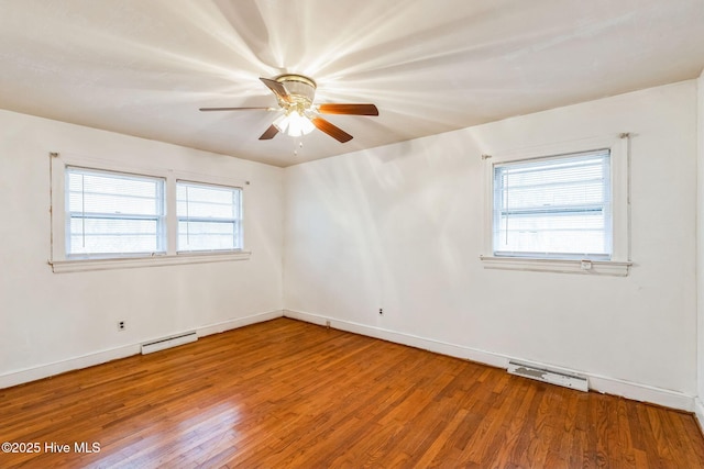 spare room with ceiling fan, hardwood / wood-style flooring, and a healthy amount of sunlight