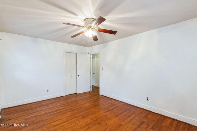 unfurnished bedroom featuring ceiling fan, wood-type flooring, and a closet