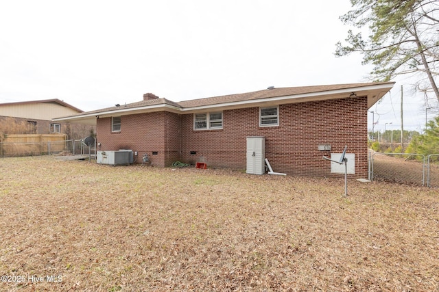 rear view of house featuring a lawn