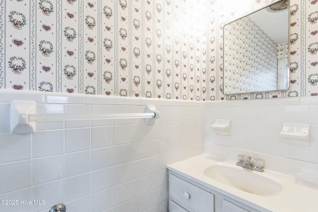 bathroom with vanity and tile walls