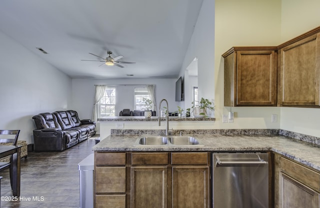 kitchen featuring ceiling fan, dark hardwood / wood-style flooring, stainless steel dishwasher, and sink