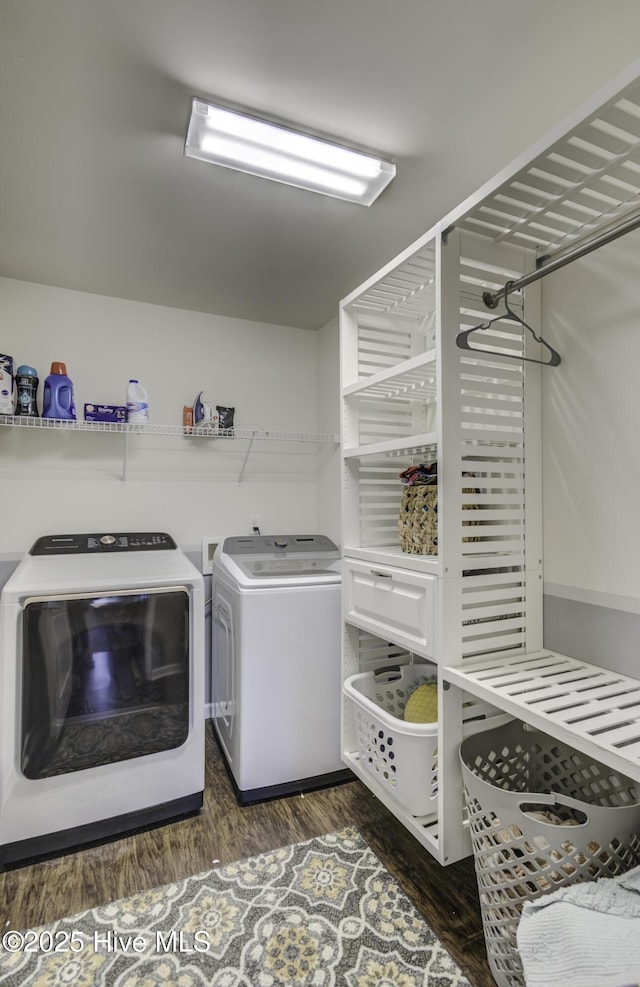 laundry area with dark hardwood / wood-style floors and washer and clothes dryer