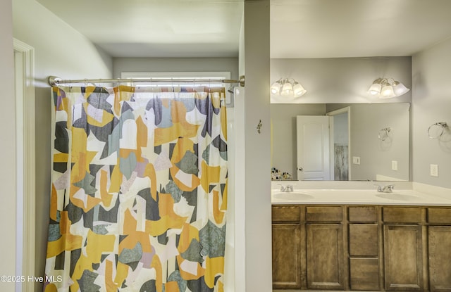 bathroom featuring a sink, a shower with shower curtain, and double vanity