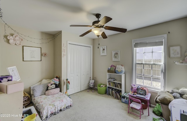 interior space with ceiling fan and carpet