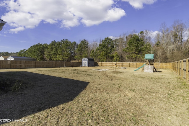 view of yard with a playground and a storage unit