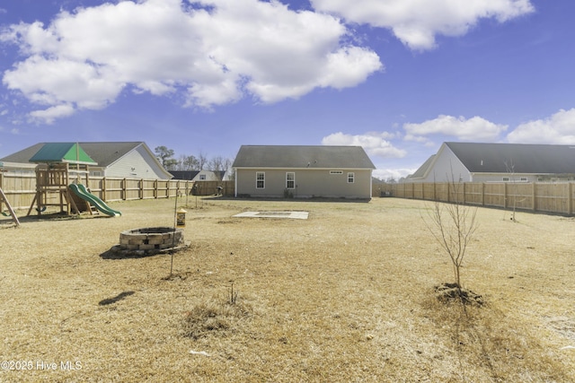 view of yard with a playground and a fire pit