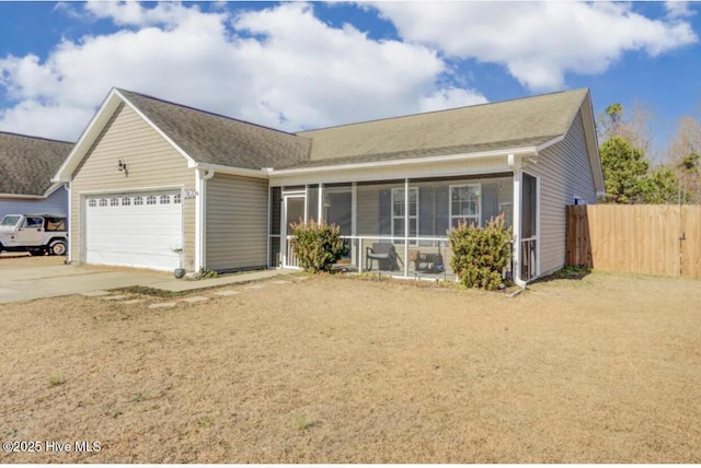 single story home featuring a garage, concrete driveway, fence, and a sunroom