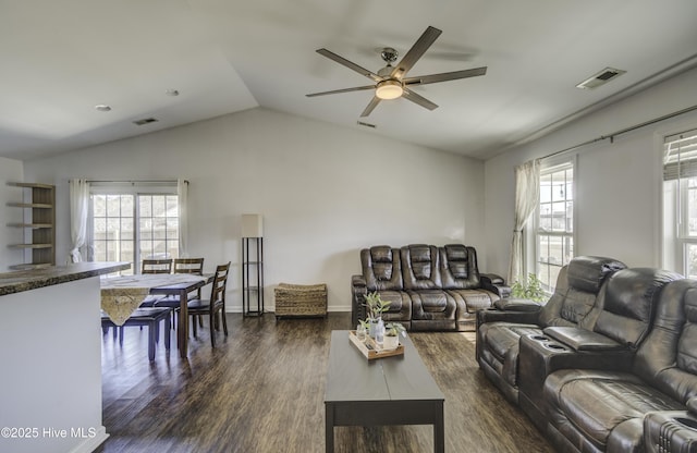 living room with ceiling fan, dark hardwood / wood-style flooring, and vaulted ceiling