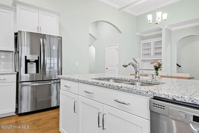 kitchen with sink, white cabinetry, crown molding, appliances with stainless steel finishes, and light hardwood / wood-style floors