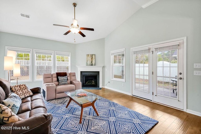 living room featuring lofted ceiling, hardwood / wood-style flooring, and ceiling fan