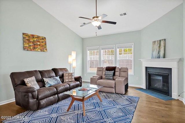 living room featuring lofted ceiling, hardwood / wood-style floors, and ceiling fan