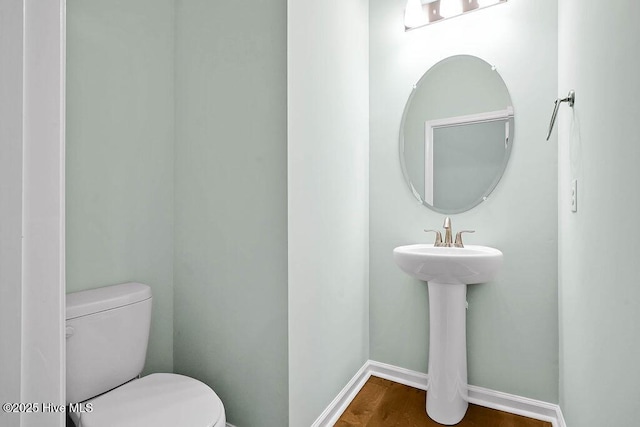 bathroom featuring toilet and hardwood / wood-style floors