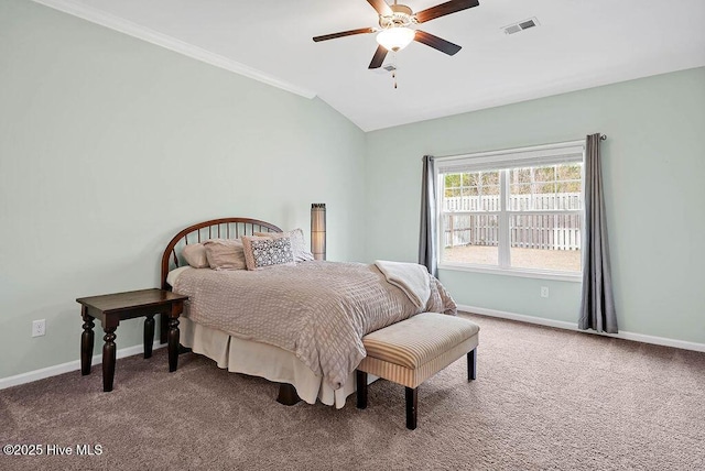 carpeted bedroom featuring crown molding, lofted ceiling, and ceiling fan