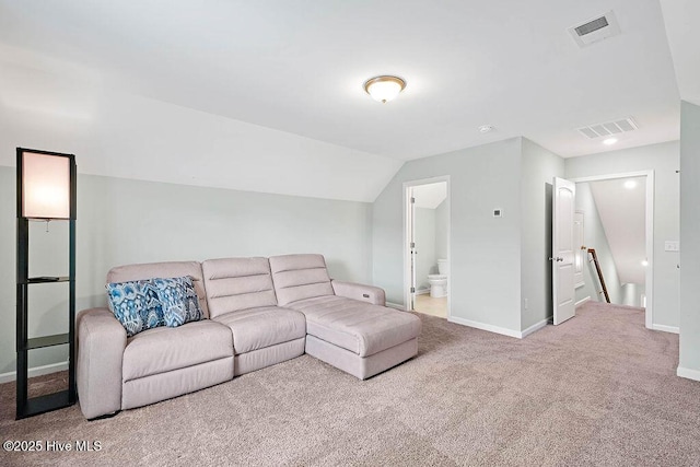 carpeted living room with lofted ceiling