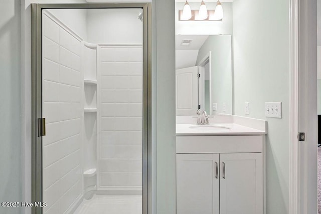 bathroom featuring vanity and tiled shower