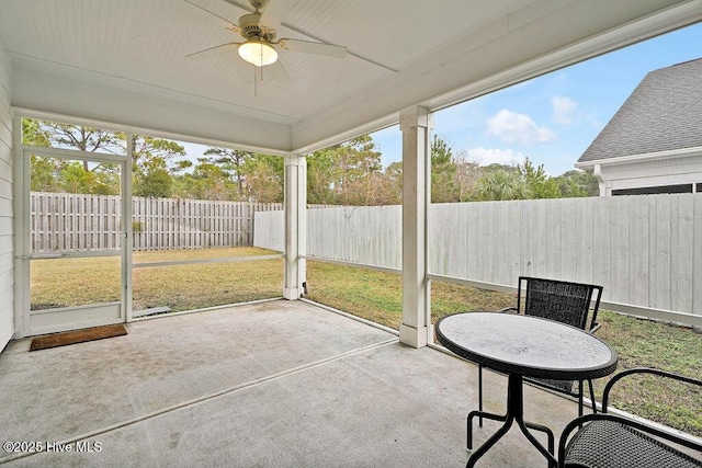 unfurnished sunroom with ceiling fan and plenty of natural light