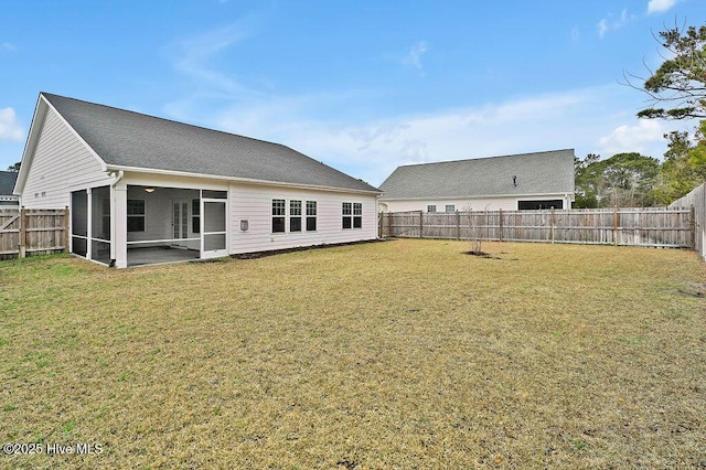 back of property with a yard and a sunroom