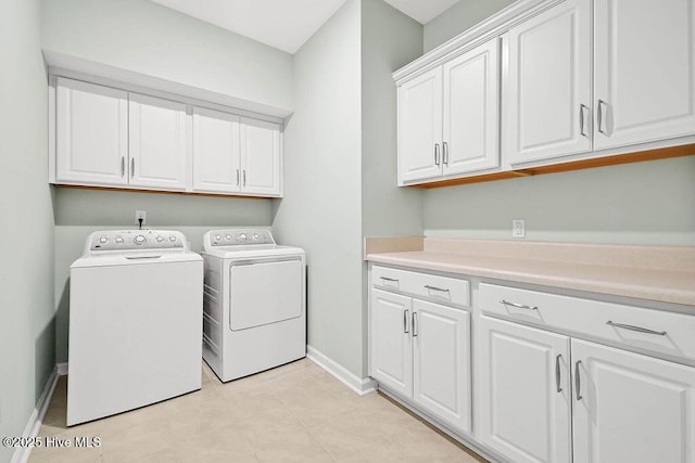 washroom featuring cabinets and separate washer and dryer