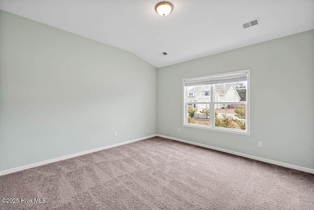 unfurnished room with lofted ceiling and carpet flooring