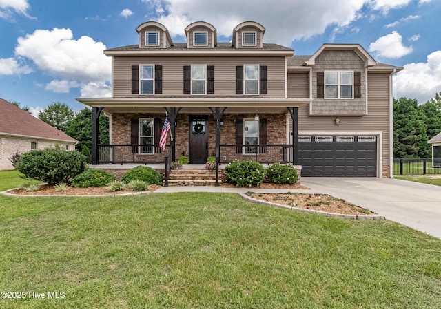 view of front of property with a garage, covered porch, and a front yard