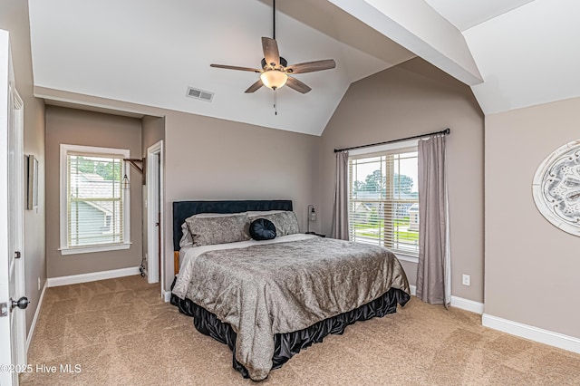 carpeted bedroom featuring multiple windows, vaulted ceiling, and ceiling fan