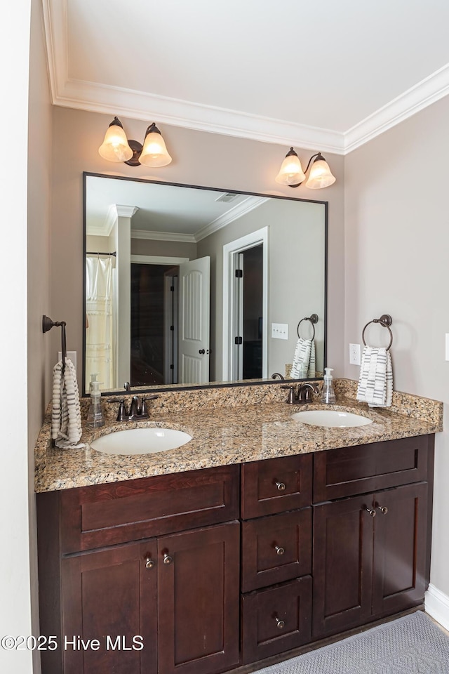 bathroom featuring crown molding and vanity