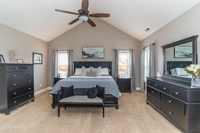 bedroom featuring ceiling fan, multiple windows, high vaulted ceiling, and light carpet